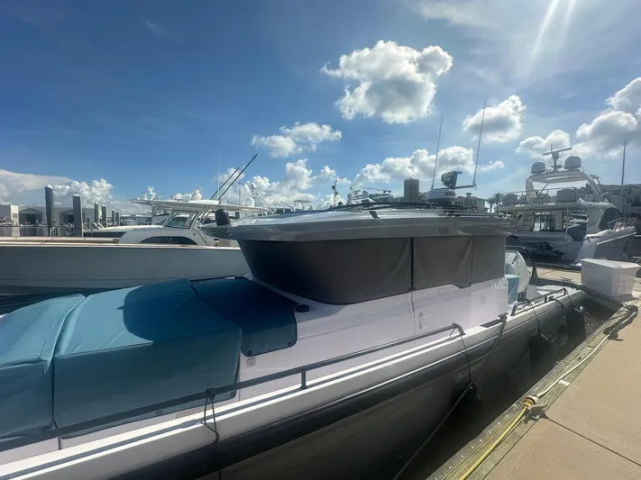 Empoleon Yacht Photos Pics 2025 Axopar 37XC CROSS CABIN BRABUS Trim docked under a bright blue sky.