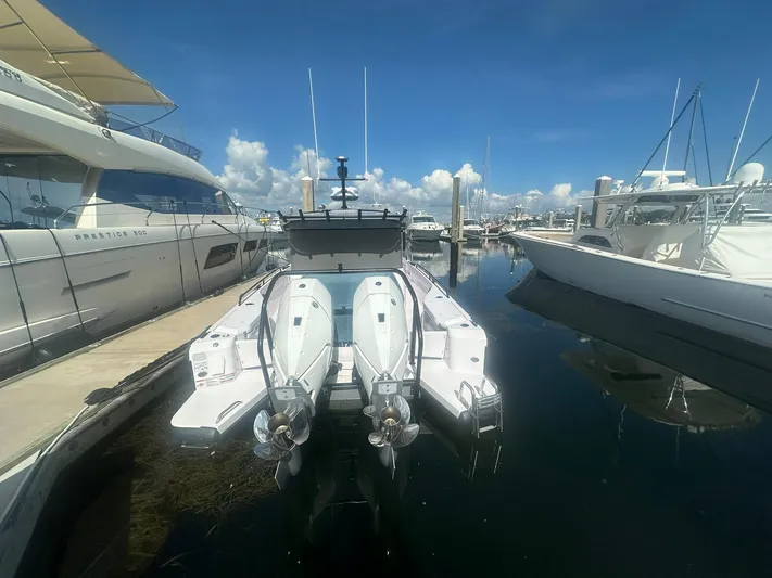 Empoleon Yacht Photos Pics 2025 Axopar 37XC CROSS CABIN BRABUS Trim docked at marina, rear view.