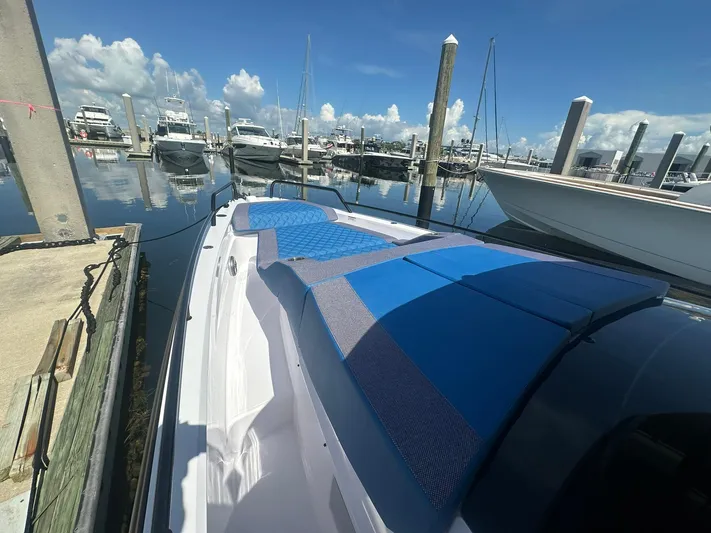Empoleon Yacht Photos Pics 2025 Axopar 37XC CROSS CABIN BRABUS Trim docked at marina under clear blue sky.