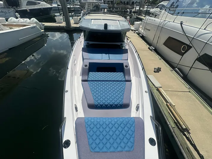 Empoleon Yacht Photos Pics 2025 Axopar 37XC CROSS CABIN BRABUS Trim docked, featuring blue quilted seating.