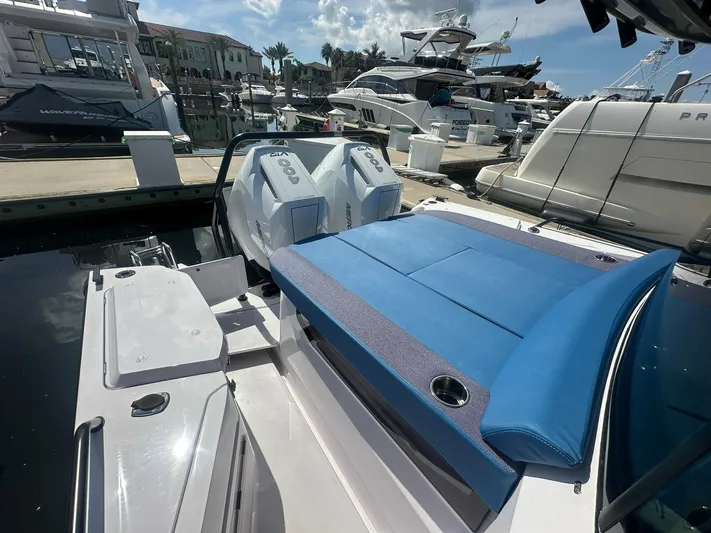 Empoleon Yacht Photos Pics 2025 Axopar 37XC CROSS CABIN BRABUS Trim with blue seating, docked at marina.