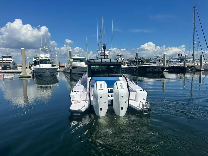 Empoleon Yacht Photos Pics 2025 Axopar 37XC CROSS CABIN BRABUS Trim docked at marina under blue sky.