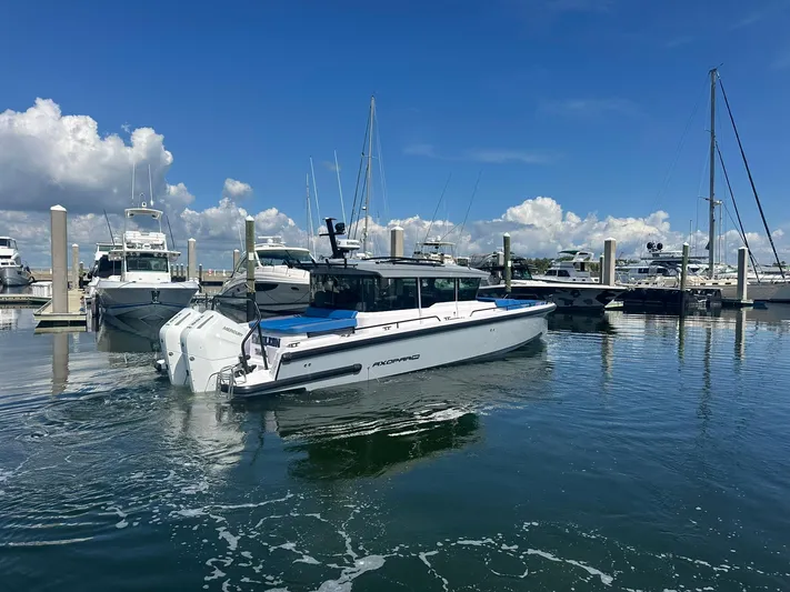Empoleon Yacht Photos Pics 2025 Axopar 37XC CROSS CABIN BRABUS Trim boat docked in a marina under blue skies.