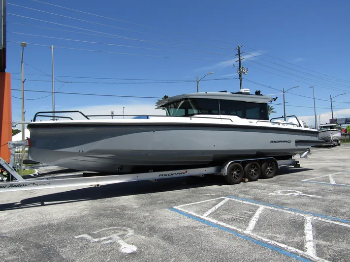 Empoleon Yacht Photos Pics 2025 Axopar 37XC CROSS CABIN BRABUS Trim boat on trailer, parked outdoors.