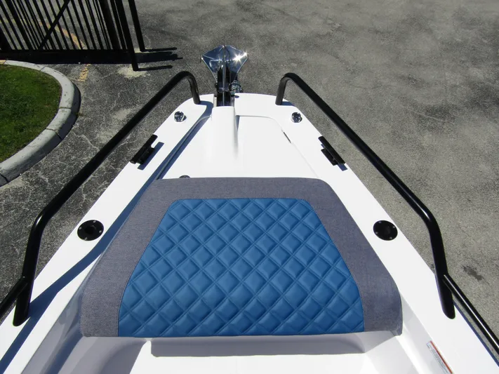 Empoleon Yacht Photos Pics Bow seating area of 2025 Axopar 37XC CROSS CABIN BRABUS Trim with blue quilted upholstery.