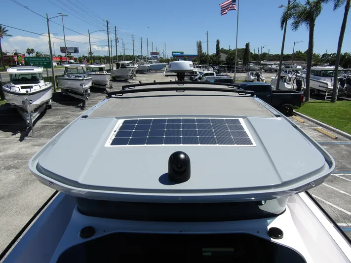 Empoleon Yacht Photos Pics 2025 Axopar 37XC CROSS CABIN BRABUS Trim with solar panel on roof, parked outdoors.