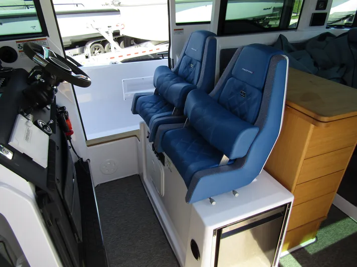 Empoleon Yacht Photos Pics 2025 Axopar 37XC CROSS CABIN BRABUS interior with blue seating and modern dashboard.