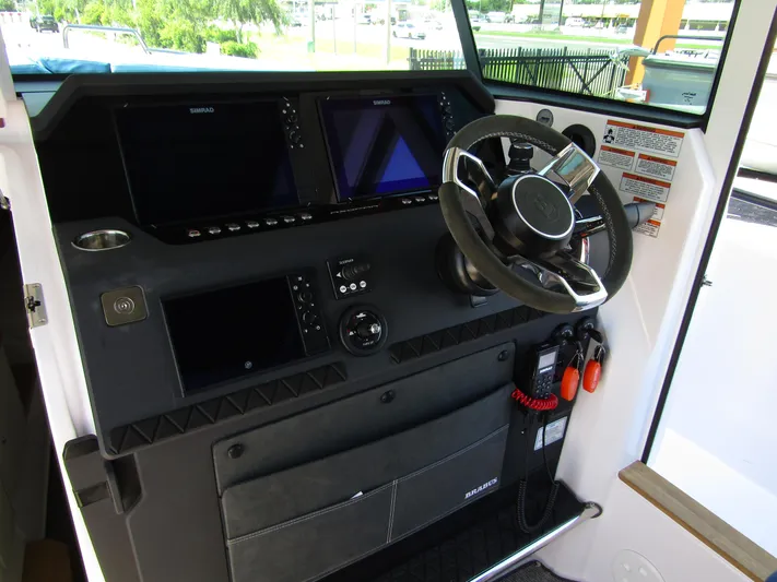 Empoleon Yacht Photos Pics 2025 Axopar 37XC CROSS CABIN BRABUS Trim dashboard with steering wheel and navigation screens.