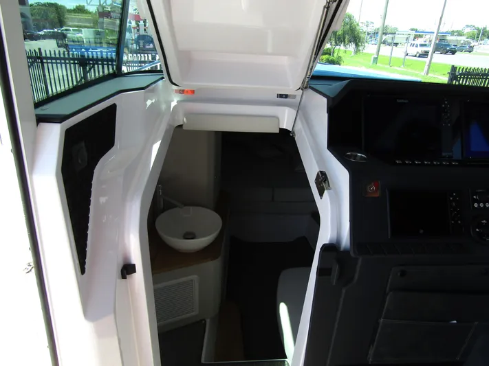 Empoleon Yacht Photos Pics 2025 Axopar 37XC CROSS CABIN BRABUS interior with modern helm and compact sink.