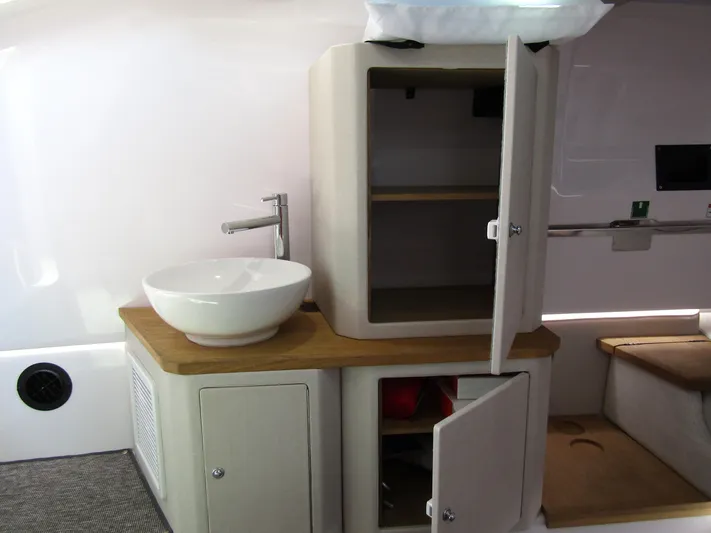 Empoleon Yacht Photos Pics Interior of 2025 Axopar 37XC CROSS CABIN BRABUS Trim with modern sink and storage cabinets.