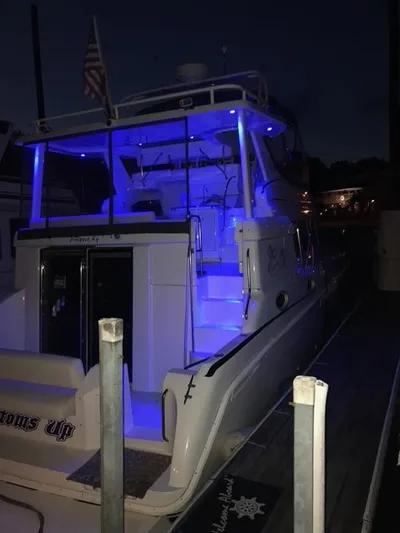 Bottoms Up Yacht Photos Pics 1996 Silverton 442 Cockpit Motor Yacht with blue lighting at dock.