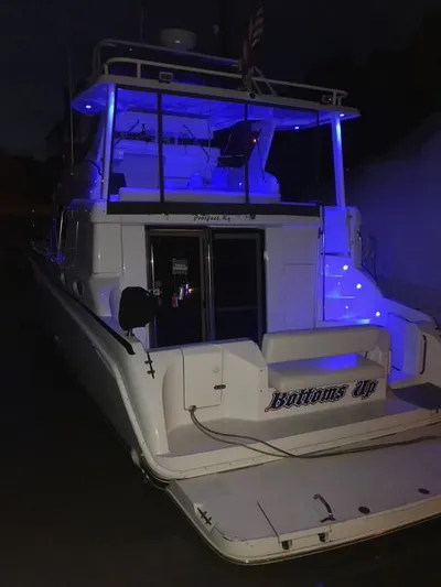 Bottoms Up Yacht Photos Pics 1996 Silverton 442 Cockpit Motor Yacht illuminated at night.