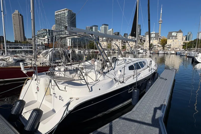 Tru Blu Yacht Photos Pics Sailboat docked in urban marina, Hunter 39 model, 2010, with city skyline backdrop.