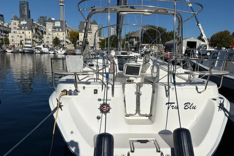 Tru Blu Yacht Photos Pics Hunter 39 sailboat docked in marina, city skyline in background, 2010 model.