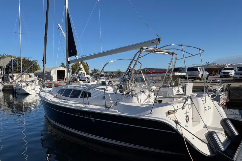 Tru Blu Yacht Photos Pics 2010 Hunter 39 sailboat docked at marina under clear blue sky.