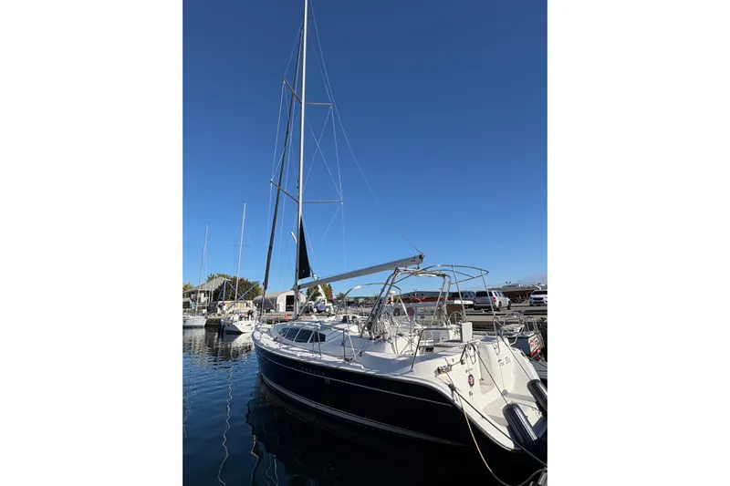 Tru Blu Yacht Photos Pics 2010 Hunter 39 sailboat docked in marina under clear blue sky.