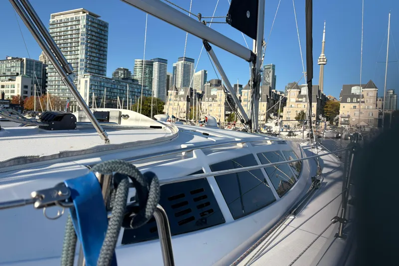 Tru Blu Yacht Photos Pics Sailboat Hunter 39 (2010) docked in urban marina with city skyline backdrop.