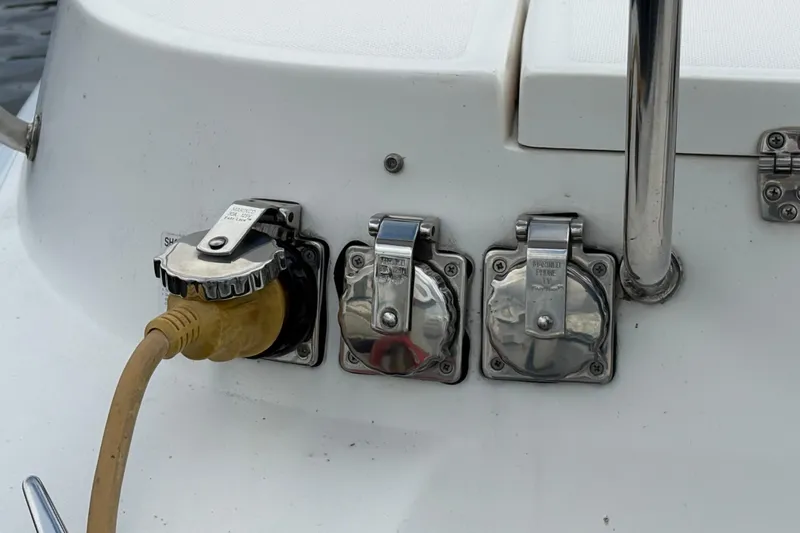 Tru Blu Yacht Photos Pics Power outlets on a 2010 Hunter 39 boat with a connected yellow cable.
