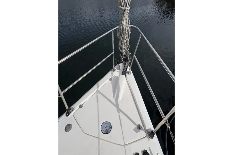 Tru Blu Yacht Photos Pics Bow of 2010 Hunter 39 sailboat with stainless steel railings and calm water.