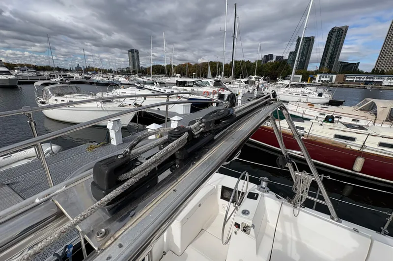 Tru Blu Yacht Photos Pics 2010 Hunter 39 sailboat docked in a marina with city skyline background.