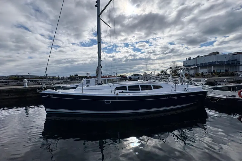 Tru Blu Yacht Photos Pics Sailboat docked at marina, Hunter 39 model, 2010, under cloudy sky.