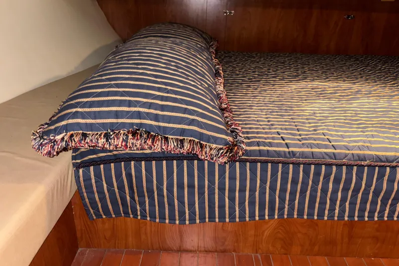 Tru Blu Yacht Photos Pics Cozy cabin bed with striped bedding in 2010 Hunter 39 yacht interior.