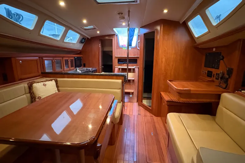 Tru Blu Yacht Photos Pics Luxurious 2010 Hunter 39 yacht interior with wood finish, dining area, and navigation station.