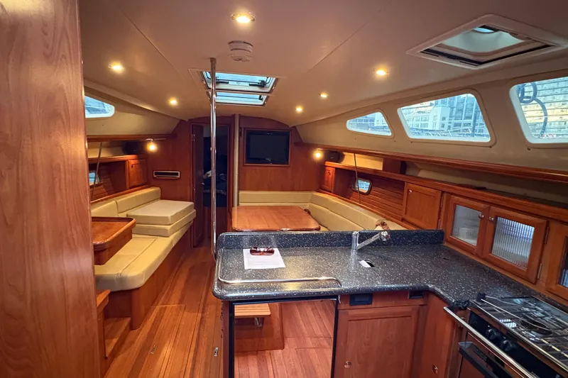 Tru Blu Yacht Photos Pics Luxurious interior of 2010 Hunter 39 yacht with modern kitchen and seating area.