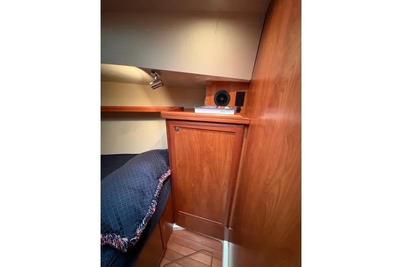 Tru Blu Yacht Photos Pics Cozy cabin interior of 2010 Hunter 39 sailboat with wooden cabinetry and bedding.