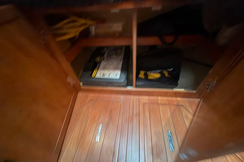 Tru Blu Yacht Photos Pics Wooden cabinet interior on a 2010 Hunter 39 sailboat, showing storage space.