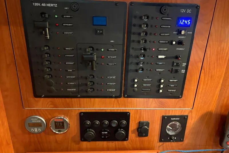 Tru Blu Yacht Photos Pics Electrical control panel on a 2010 Hunter 39 yacht, featuring various switches and gauges.