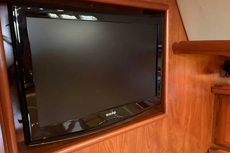 Tru Blu Yacht Photos Pics Flat-screen TV mounted on wooden interior of 2010 Hunter 39 yacht.
