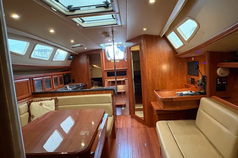 Tru Blu Yacht Photos Pics Luxurious interior of 2010 Hunter 39 sailboat with wood finish and seating area.