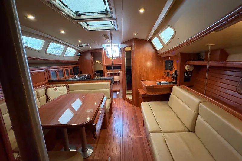 Tru Blu Yacht Photos Pics Luxurious interior of a 2010 Hunter 39 sailboat with wood finishes and seating area.