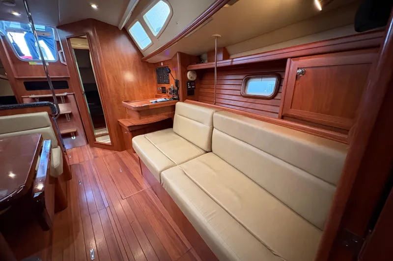 Tru Blu Yacht Photos Pics Luxurious interior of 2010 Hunter 39 yacht with wooden finishes and beige seating.