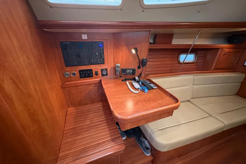 Tru Blu Yacht Photos Pics Interior of 2010 Hunter 39 sailboat with navigation station and seating area.
