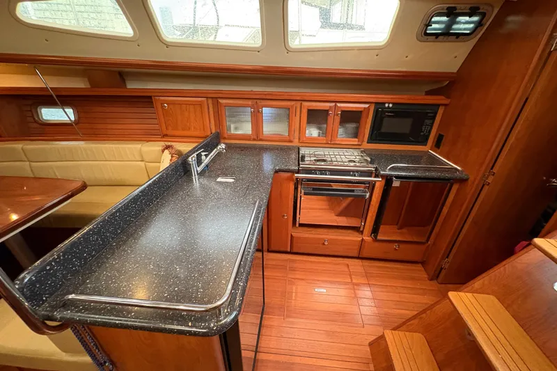 Tru Blu Yacht Photos Pics Luxurious 2010 Hunter 39 yacht interior with modern kitchen and wooden cabinetry.
