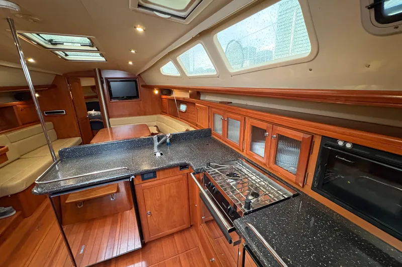 Tru Blu Yacht Photos Pics Luxurious interior of 2010 Hunter 39 yacht with modern kitchen and seating area.