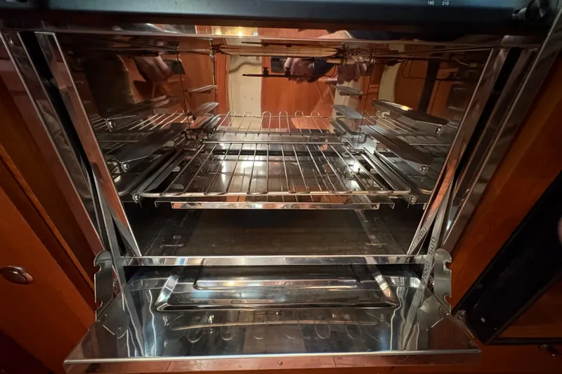 Tru Blu Yacht Photos Pics Open oven interior with metal racks, reflecting light, in a Hunter 39 model, 2010.
