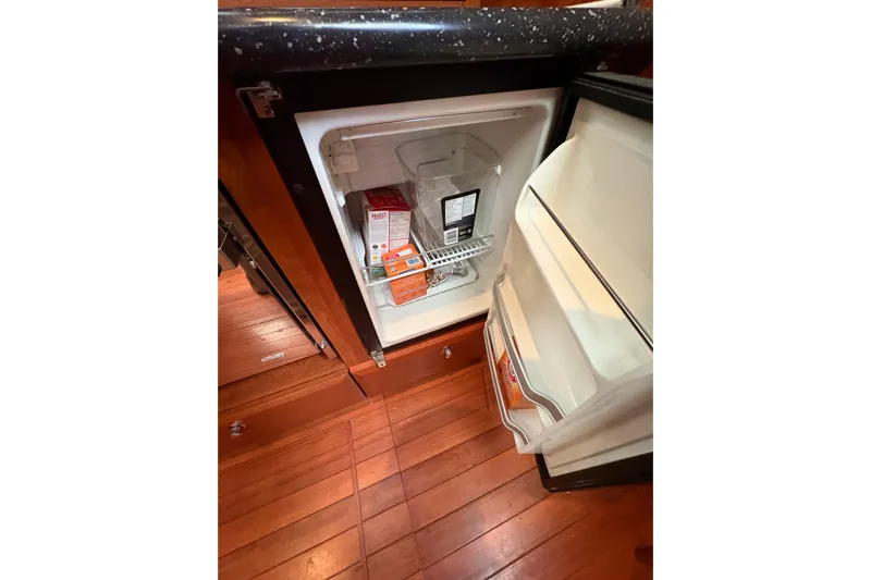 Tru Blu Yacht Photos Pics Open refrigerator in 2010 Hunter 39 yacht kitchen with wooden flooring.