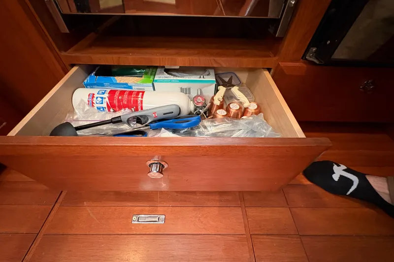 Tru Blu Yacht Photos Pics Open drawer with assorted tools and supplies on a Hunter 39, 2010 model.