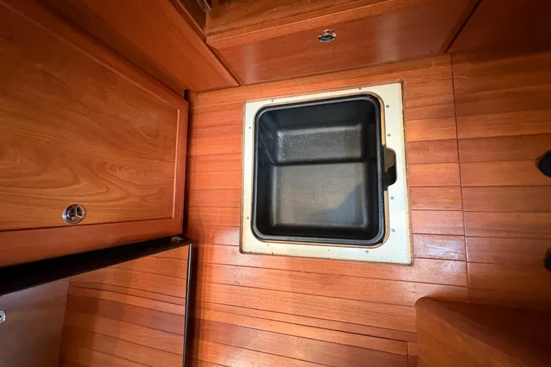 Tru Blu Yacht Photos Pics Wooden floor with storage compartment on a 2010 Hunter 39 boat.