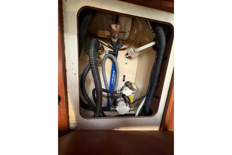 Tru Blu Yacht Photos Pics Interior view of a 2010 Hunter 39 yacht showing plumbing and wiring components.