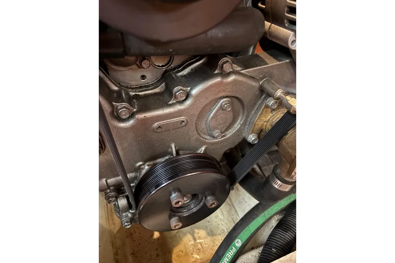 Tru Blu Yacht Photos Pics Close-up of a 2010 Hunter 39 engine component with visible belt and pulley system.