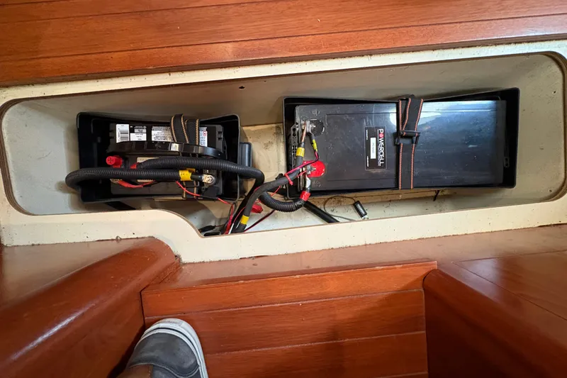 Tru Blu Yacht Photos Pics Battery compartment of a 2010 Hunter 39 sailboat, featuring dual batteries and wiring.