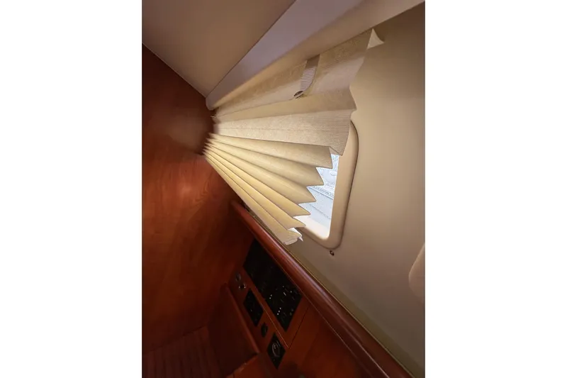 Tru Blu Yacht Photos Pics Interior of 2010 Hunter 39 yacht with window blinds and wooden paneling.