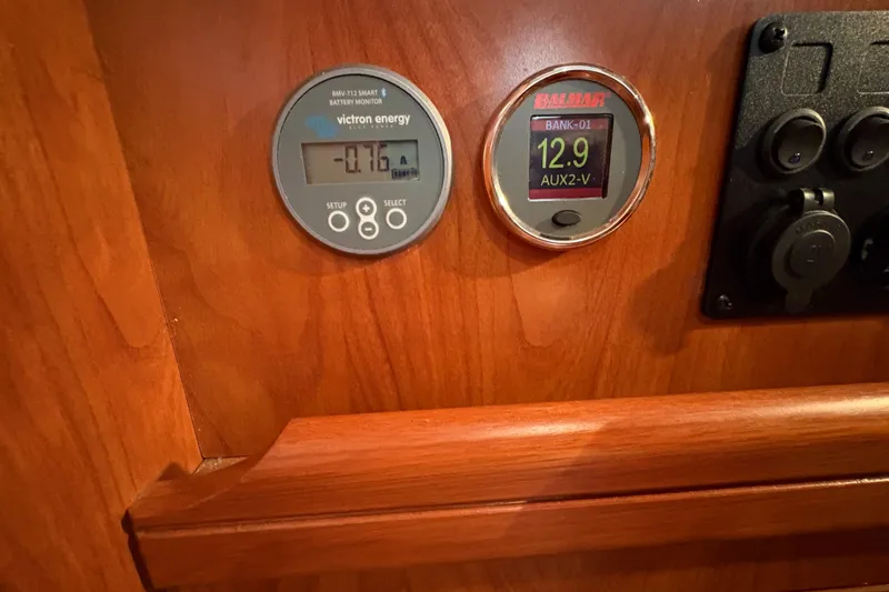 Tru Blu Yacht Photos Pics Battery monitors on a 2010 Hunter 39 yacht dashboard, displaying voltage and current readings.