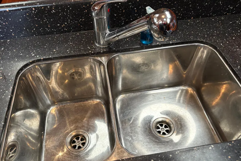 Tru Blu Yacht Photos Pics Stainless steel double sink with modern faucet on speckled countertop, Hunter 39, 2010 model.