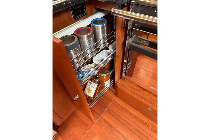 Tru Blu Yacht Photos Pics Kitchen storage in 2010 Hunter 39 yacht with canned goods and beverages.