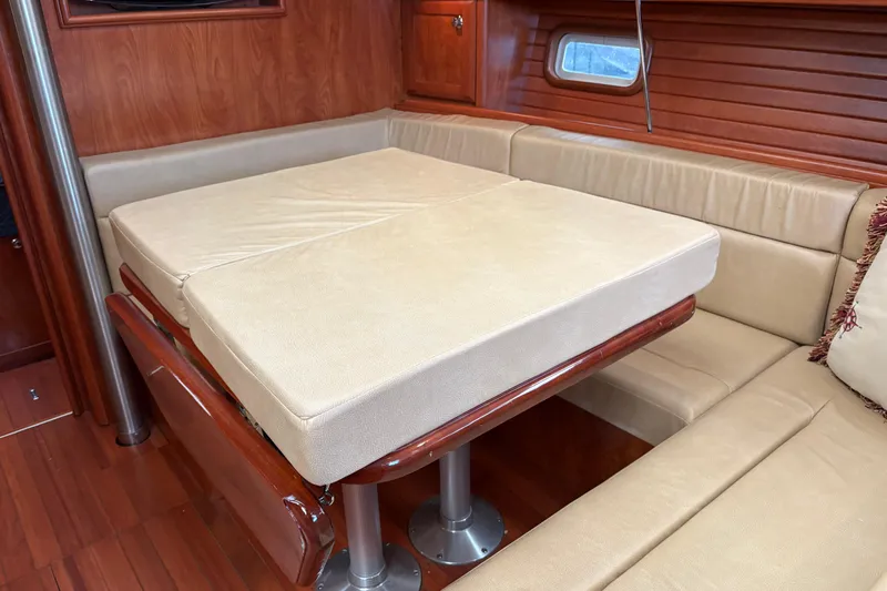 Tru Blu Yacht Photos Pics Interior of 2010 Hunter 39 yacht with convertible dining table and beige seating.